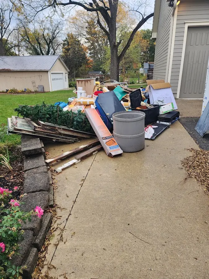 Dumpster being loaded with debris for Estate Cleanout Dumpster Rental in Claremore